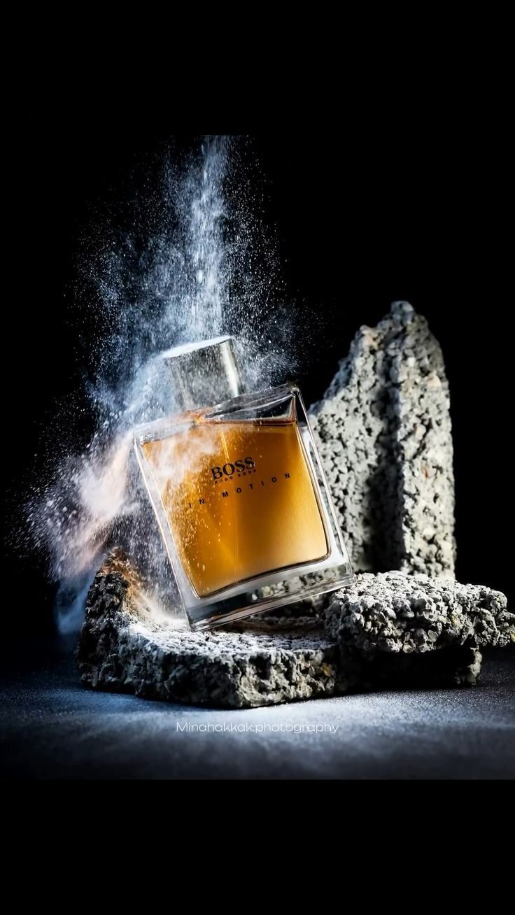 Hugo Boss In Motion perfume advertisement with dust and stone